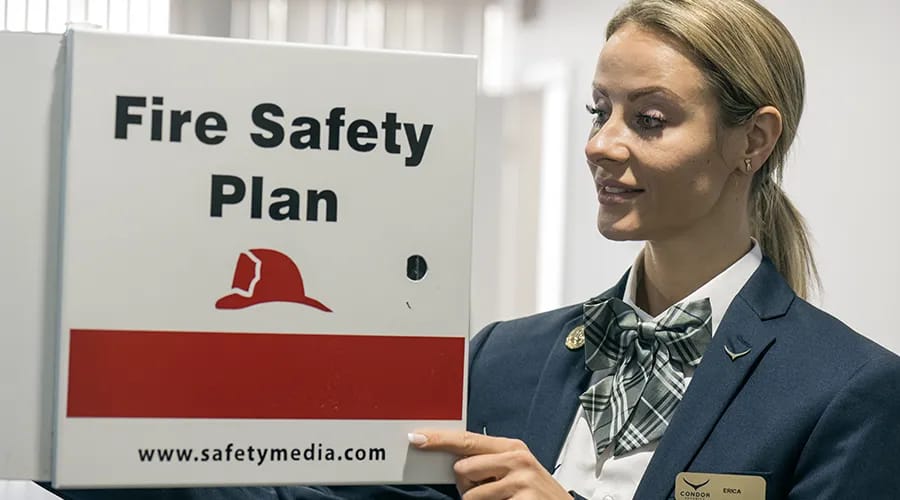 A woman is holding a fire safety plan in her hand-condor security(fire Safety Training) (Security Training Toronto)