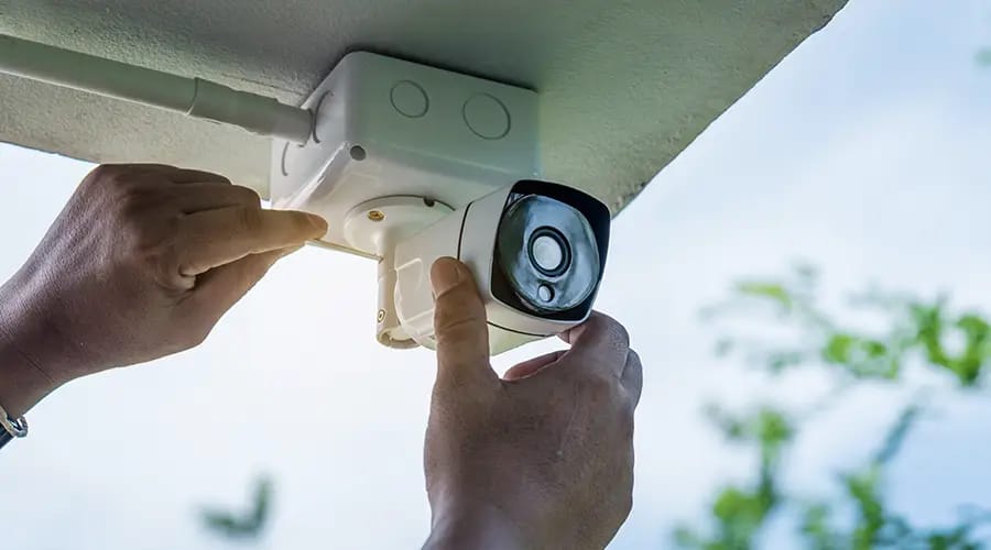 a people setting a CC camera-condor security Executive Protection Toronto (Security Systems Installation)